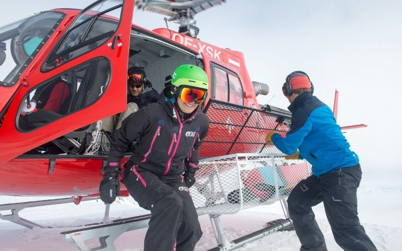 heli-ski-skiers-climbing-out-of-helicopter-min