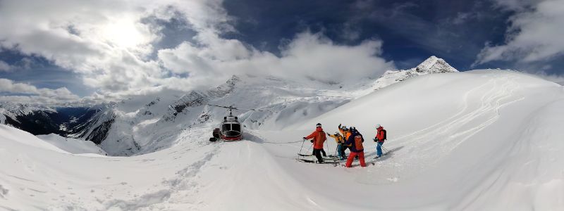 heli-skiing-group-on-slopes-min