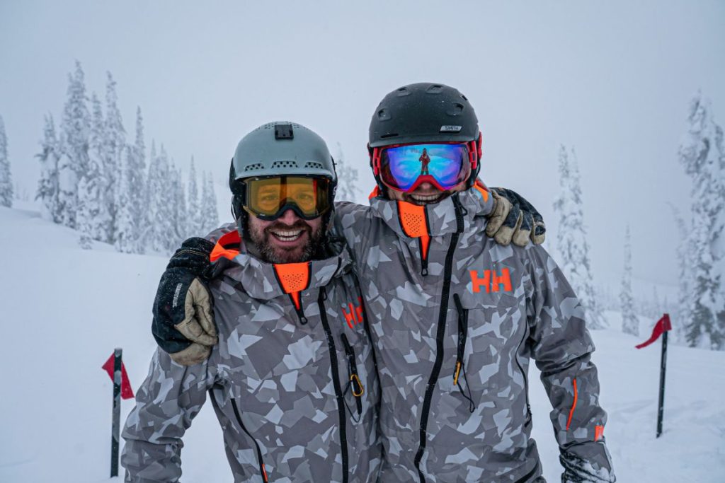 helicopter-skiing-skiers-pose-for-a-photo-before-heading-down-slopes-min