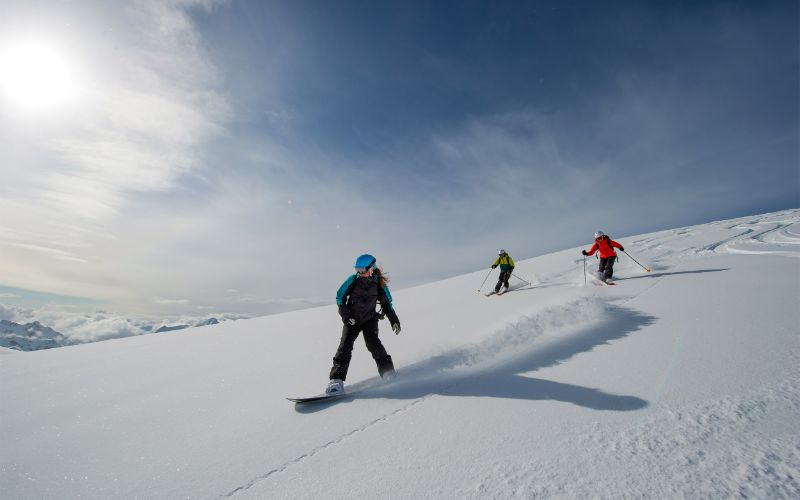 off-piste-skiing-three-skiers-heading-through-backcountry-min