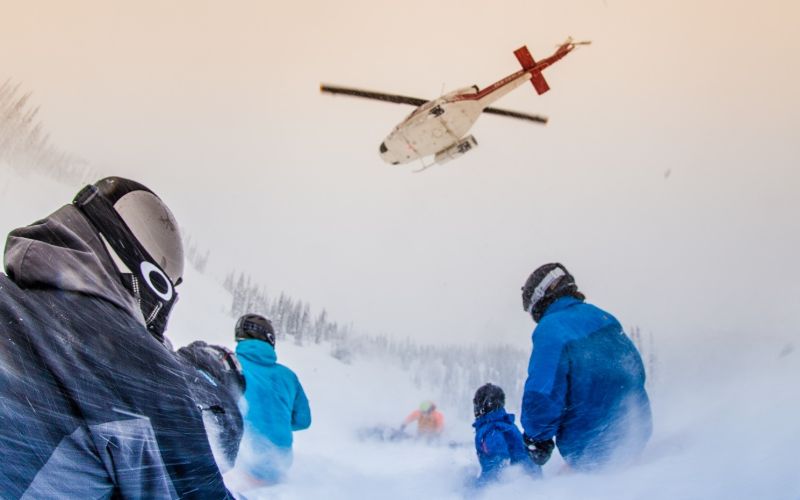 heli-skiing-bc-prices-group-watches-helicopter-min
