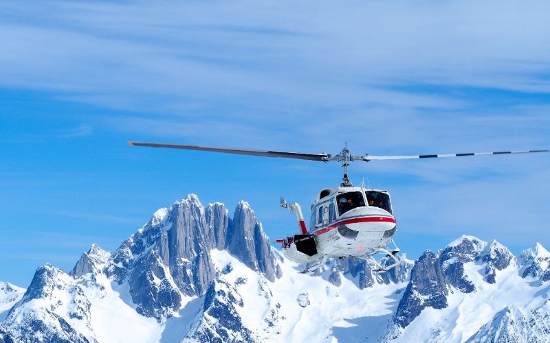 heli-skiing-bc-prices-helicopter-flying-min