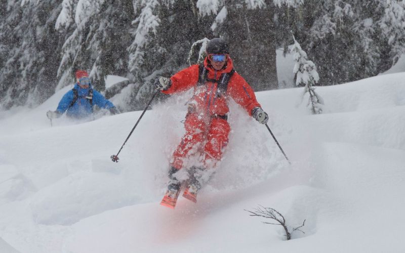 heli-skiing-bc-prices-skiing-down-mountain-min