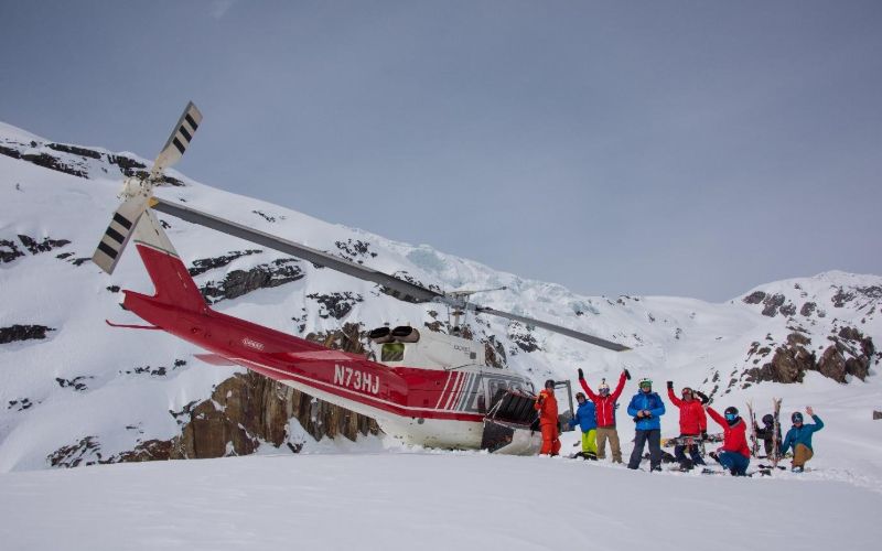 helicopter-skiing-canada-group-next-to-helicopter-min